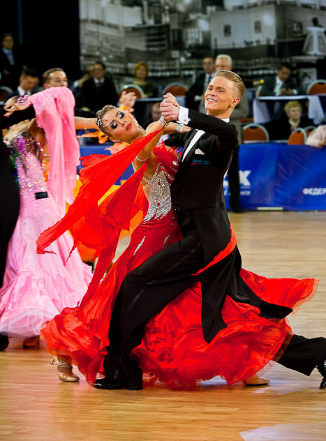 dance competitors in motion with a bold red dress